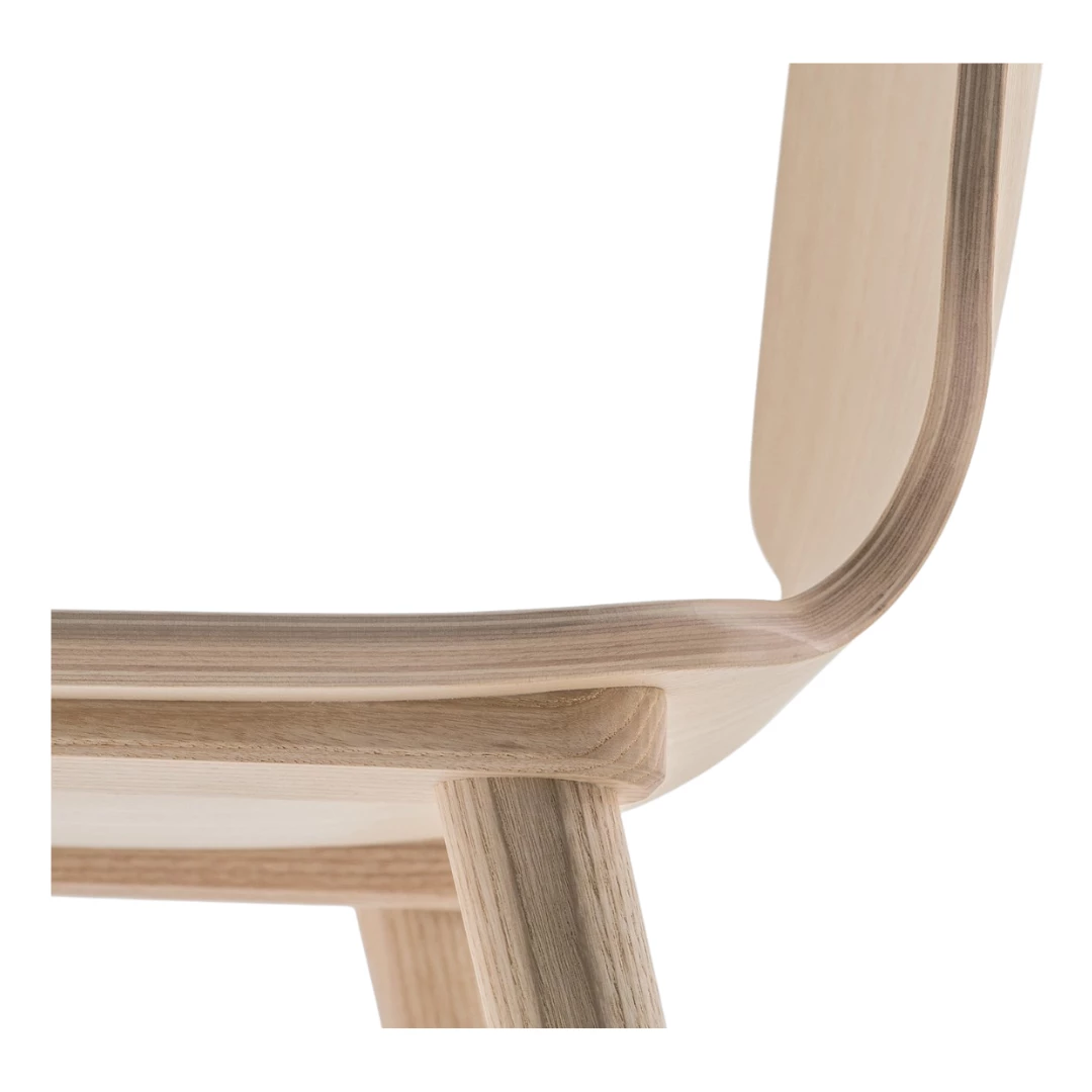 Chair featuring a curved ash plywood shell in variable thickness and solid ash wood legs for a warm, natural look. Available in a range of contemporary finishes: blue, azur, dark green, mint green, red, pink, dark brown, and brown. A stylish and comfortable choice for hospitality interiors.